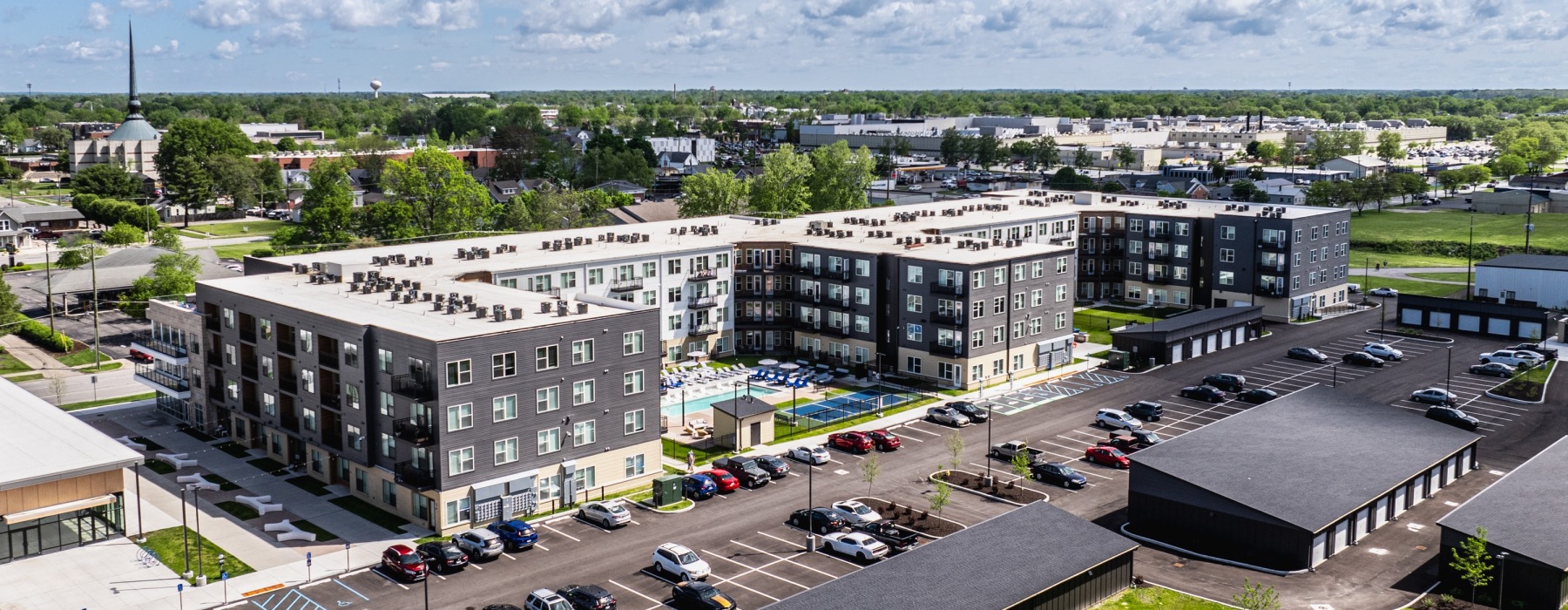 aerial view of apartment community with city in background