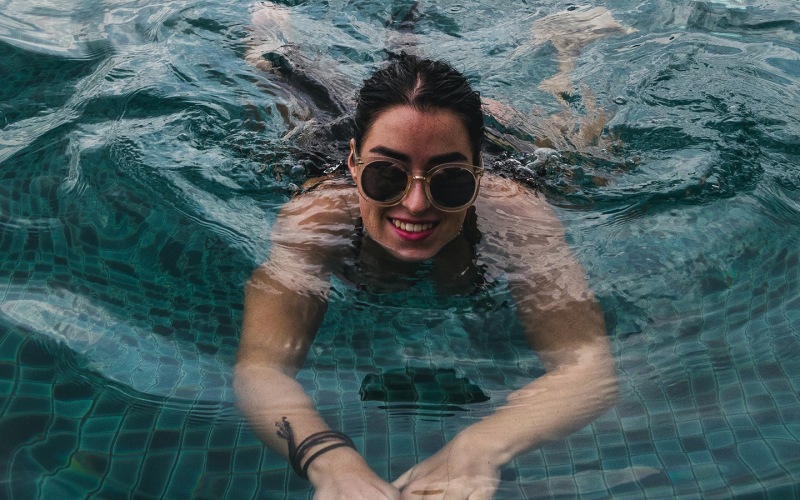 lifestyle image of a woman in a pool