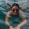 lifestyle image of a woman in a pool
